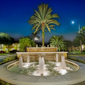 Night View Of A Lighted Fountain At The Community's Main Entrnace